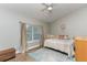 Serene bedroom featuring a king bed, wood floors, and a window with natural light at 558 Pinebranch Cir, Winter Springs, FL 32708