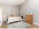Bright bedroom features a queen bed, light walls, hardwood flooring, and an ensuite bathroom at 558 Pinebranch Cir, Winter Springs, FL 32708