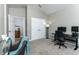 Bedroom with gray walls, two-door closet, and a personal workspace with dual monitors at 558 Pinebranch Cir, Winter Springs, FL 32708