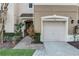 Charming townhouse exterior with an attached garage, neutral colors, and well-manicured landscaping at 558 Pinebranch Cir, Winter Springs, FL 32708