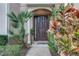 Welcoming front door surrounded by lush landscaping and an arched entryway at 558 Pinebranch Cir, Winter Springs, FL 32708