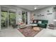 Bright living room featuring a green sofa, area rug, and sliding glass doors to the screened porch at 558 Pinebranch Cir, Winter Springs, FL 32708