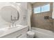 Bright bathroom with a vanity, a large mirror, and a shower-tub combo at 581 Hollingshead Loop, Davenport, FL 33896