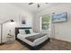 Relaxing bedroom featuring neutral walls, wood floors, and a mounted television at 581 Hollingshead Loop, Davenport, FL 33896