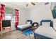 ' bedroom featuring two twin beds, a chalkboard, and Mickey Mouse curtains at 581 Hollingshead Loop, Davenport, FL 33896