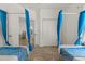 Whimsical bedroom with two twin beds featuring ocean-themed decor, light blue accents, and access to a bathroom at 581 Hollingshead Loop, Davenport, FL 33896