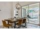 Modern dining room features stylish light fixture and sliding glass doors to the outdoor living space at 581 Hollingshead Loop, Davenport, FL 33896