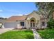 Charming one-story home with attached garage, well-manicured lawn, and inviting entryway at 581 Hollingshead Loop, Davenport, FL 33896
