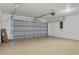 Spacious two-car garage with a smooth concrete floor, a standard garage door, and ample storage space at 581 Hollingshead Loop, Davenport, FL 33896