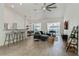 Open living space featuring breakfast bar, a dining table, a sectional sofa and sliding glass door with a pool view at 581 Hollingshead Loop, Davenport, FL 33896