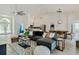 Bright, open living room with tile floors, comfortable seating, and view into dining and kitchen areas at 581 Hollingshead Loop, Davenport, FL 33896
