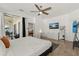 Bright main bedroom with a ceiling fan, a TV, a view to the outdoor patio, and light hardwood flooring at 581 Hollingshead Loop, Davenport, FL 33896
