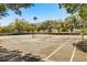 Outdoor community tennis court bordered by trees and shrubbery for the enjoyment of residents and their guests at 581 Hollingshead Loop, Davenport, FL 33896