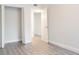 Bright bedroom featuring wood-look floors, closet and an ensuite bathroom at 6021 Village Cir # 6021, Orlando, FL 32822