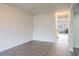 Well-lit bedroom with new gray laminate flooring and neutral paint at 6021 Village Cir # 6021, Orlando, FL 32822