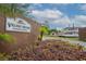 Village Square Condominiums entrance sign with boat and waterway in background at 6021 Village Cir # 6021, Orlando, FL 32822