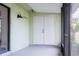 Covered front entrance featuring a double-door entrance, and black sconce lighting at 6021 Village Cir # 6021, Orlando, FL 32822