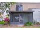 Charming condo exterior featuring a screened-in patio and upper-level balcony at 6021 Village Cir # 6021, Orlando, FL 32822