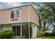 Charming exterior of a townhome featuring classic architecture and lush landscaping around the property at 6021 Village Cir # 6021, Orlando, FL 32822