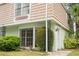 Charming exterior of a townhome featuring classic architecture and lush landscaping around the property at 6021 Village Cir # 6021, Orlando, FL 32822