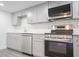 Updated kitchen with gray cabinets, modern appliances, and subway tile backsplash offers sleek appeal at 6021 Village Cir # 6021, Orlando, FL 32822