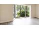 Bright living room with a large bay window, new gray laminate floors, and fresh neutral paint at 6021 Village Cir # 6021, Orlando, FL 32822