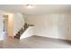 Bright living room featuring an open staircase and new gray laminate floors with neutral paint at 6021 Village Cir # 6021, Orlando, FL 32822