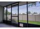 Enclosed patio showing the backyard's green lawn and privacy fence at 6021 Village Cir # 6021, Orlando, FL 32822