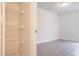Bedroom with laminate floors featuring an open closet for ample storage at 6021 Village Cir # 6021, Orlando, FL 32822