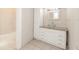 Bathroom vanity features a glass bowl sink, granite countertop, and storage at 611 Sanford Ave, Sanford, FL 32771
