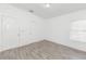 Well-lit bedroom featuring gray tile floors and white walls at 611 Sanford Ave, Sanford, FL 32771