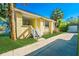 Charming yellow bungalow with a lush lawn, a separate garage, and a sunny front porch at 611 Sanford Ave, Sanford, FL 32771