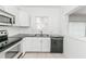 Updated kitchen with new countertops, stainless steel appliances and white cabinets at 611 Sanford Ave, Sanford, FL 32771
