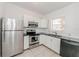 Efficient kitchen with stainless steel refrigerator, and white cabinets at 611 Sanford Ave, Sanford, FL 32771