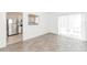 Bright living room featuring new flooring, large windows, and an open kitchen view at 611 Sanford Ave, Sanford, FL 32771