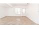 Open living area featuring a white interior, wood flooring, and natural light from windows at 611 Sanford Ave, Sanford, FL 32771