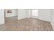 Inviting living room with wood floors, neutral tones, and a glimpse into the modern kitchen at 611 Sanford Ave, Sanford, FL 32771