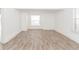Bright living room featuring hardwood floors, natural light, and crisp white walls at 611 Sanford Ave, Sanford, FL 32771