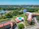 Aerial view of the complex with a community pool, lakes and surrounding landscape at 6403 Parc Corniche Dr # 4114, Orlando, FL 32821