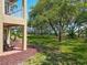 Backyard area with a patio and view of the landscaped lawn at 6403 Parc Corniche Dr # 4114, Orlando, FL 32821