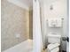Bathroom featuring a tiled shower-tub, a toilet and a towel rack at 6403 Parc Corniche Dr # 4114, Orlando, FL 32821