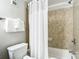 Bathroom featuring a tiled shower-tub, a toilet and a towel rack at 6403 Parc Corniche Dr # 4114, Orlando, FL 32821