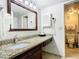Bathroom featuring a sink and vanity with granite counters and a mirror at 6403 Parc Corniche Dr # 4114, Orlando, FL 32821