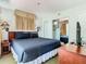 Comfortable bedroom featuring a queen bed, mirrored closet and bedside table with a lamp at 6403 Parc Corniche Dr # 4114, Orlando, FL 32821