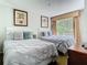Bedroom with two queen beds, palm tree artwork and window with view of the outdoors at 6403 Parc Corniche Dr # 4114, Orlando, FL 32821