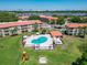 Aerial view of the community pool and playground surrounded by condos at 6403 Parc Corniche Dr # 4114, Orlando, FL 32821