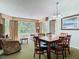Open dining area with seating for six, great natural light, and view of the living room and green spaces at 6403 Parc Corniche Dr # 4114, Orlando, FL 32821
