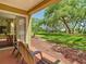 A condo patio showing peaceful parklike view with mature trees, and chairs for relaxing outdoors at 6403 Parc Corniche Dr # 4114, Orlando, FL 32821