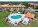 Aerial shot of a community pool, hot tub, and well-maintained pool deck with lounge seating and umbrellas at 6403 Parc Corniche Dr # 4114, Orlando, FL 32821