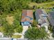 Aerial view of property and surrounding neighborhood with mature trees at 6807 Habitat Dr, St Cloud, FL 34773